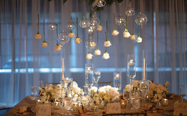 Photos by Laura Stone Photo // Guests dined under floral chandeliers and cascading flowers suspended from the ceiling.