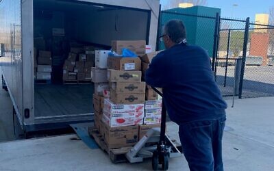 Second Helpings Delivery and Fleet Operator Enzo Albana Galateo Campos loads a pallet of food from Coolray Field last month.
