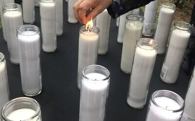 Memorial attendees lit candles in memory of those who died in the stampede.