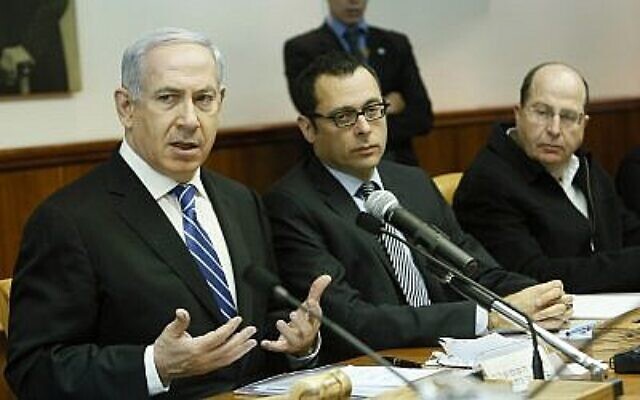 Prime Minister Benjamin Netanyahu (L), then-cabinet secretary Zvi Hauser (C) and then-defense minister Moshe Ya’alon attend the weekly cabinet meeting at the Prime Minister’s Office in Jerusalem on March 10, 2013. (Miriam Alster/Flash90)