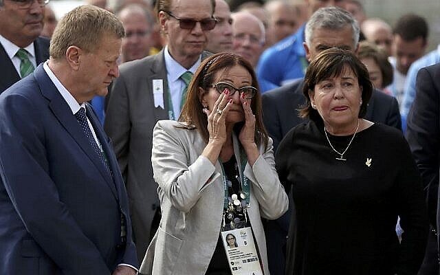 Ilana Romano, center, and Ankie Spitzer, right, widows of Israeli Olympic athletes killed by Palestinian gunmen at the 1972 Munich Olympics, attend a memorial in their husbands’ honor, ahead of the Summer Olympics in Rio de Janeiro, Brazil, Wednesday, Aug. 3, 2016. (AP Photo/Edgard Garrido, Pool)