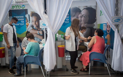 Israelis aged 60+ receive their third dose of the COVID-19 vaccine at a temporary Clalit health care center in Tel Aviv, on August 10, 2021. (Miriam Alster/Flash90)