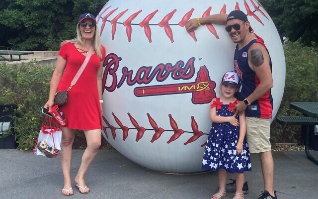 Rabbi Micah Miller, with wife April and daughter Aria at Braves game.