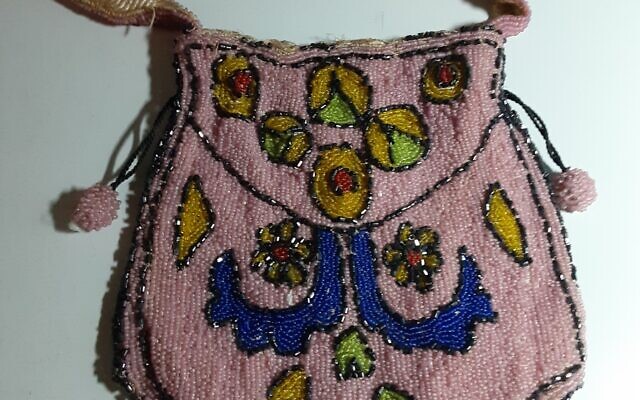 Elaborately beaded purse with unusual design and beaded fobs.