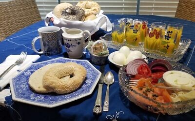 A traditional break-fast dairy menu includes lox and bagels with orange juice and hard-boiled eggs.
