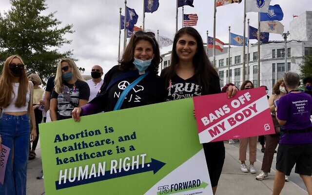 Laura Kurlander-Nagel and her daughter Lucy Kurlander hold up abortion rally signs at the march.