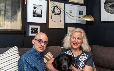 Photography by Howard Mendel//
Robin Bernat and Jon Ciliberto enjoy time in their study with black lab Winnie. Robin’s large mixed media drawing is based on the Book of Job (left).