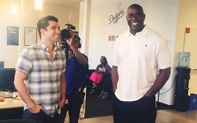Adam Wexler, CEO of PrizePicks, shares a laugh with Magic Johnson.