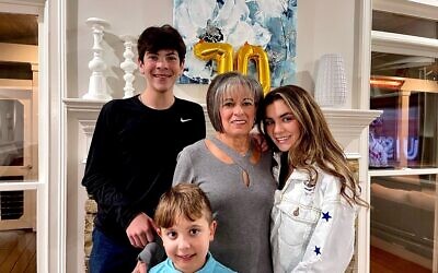 Jeanne Simon with her teenaged grandchildren, Ian and Nessa Stukalsky, and her youngest grandchild, Connor Greene.