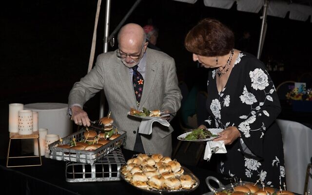 TKE members Harvey and Addie Schneider appreciate the catered buffet supper reception following the service.