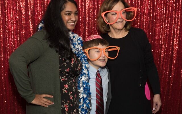 Sam’s former kindergarten teacher, Ameetha Annesse, and physical therapist Gwen Freedman celebrate with Sam at his party.