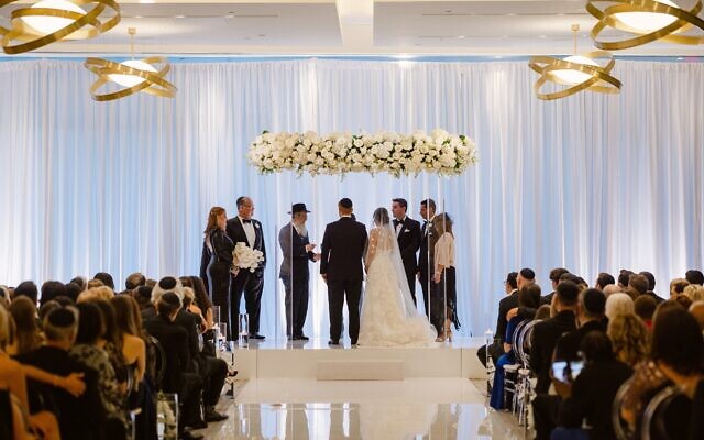The couple chose a modern Lucite chuppah. //Photo by Carter Rose Weddings