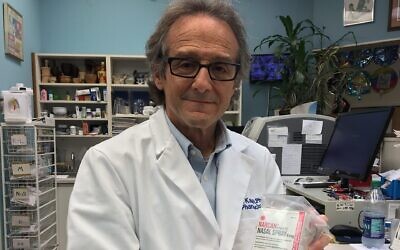 Pharmacist Ira Katz holds a box of Narcan (naloxone), a nasal spray that reverses opioid overdose.