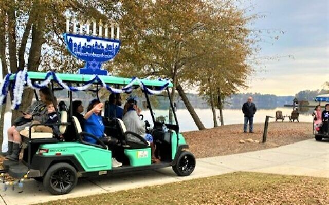 A hanukkiah is affixed to the golf cart is part of the parade.