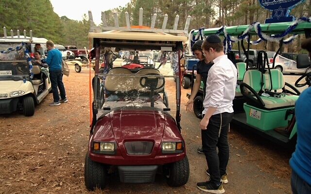 Several golf carts leading the parade carry the menorahs that will be lit.