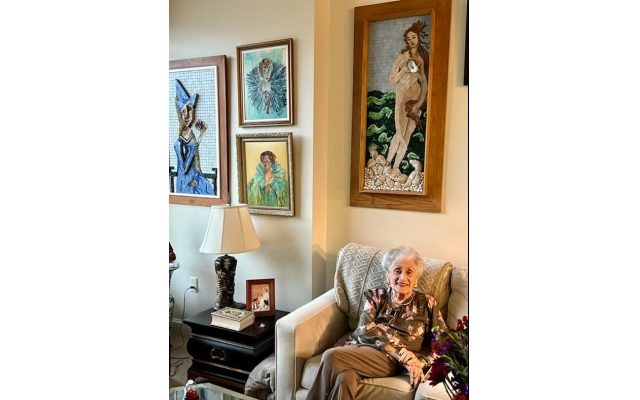 Estelle Karp with her husband’s artwork and a Sumida-base lamp.