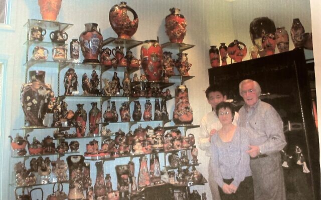 Herbert Karp with Japanese pottery assessors in front of a wall of Sumida ware.