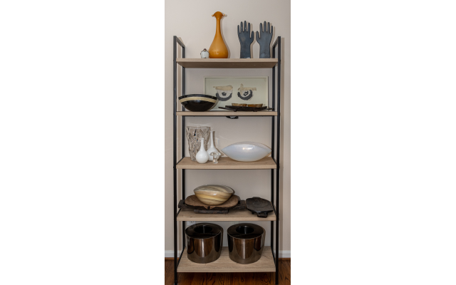 This étagère separates the kitchen from the formal living room. It features Murano and Italian glass bowls, African meat platters and found objects from Jackson's travels.