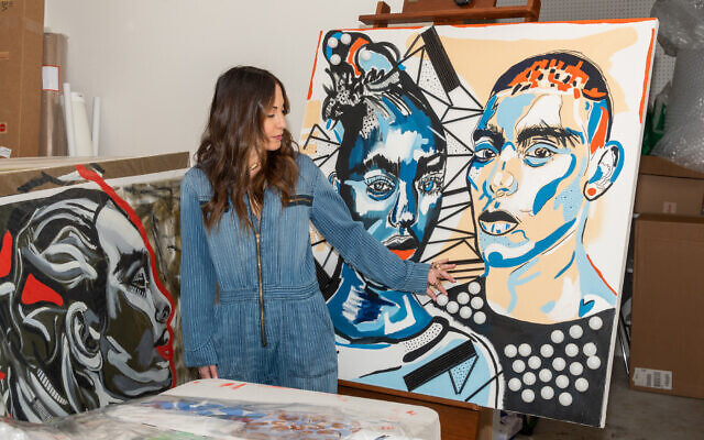 Jackson examines two of her larger works: (left) “Kali”  and (right) “Absence and Presence,” portraying South African themes.