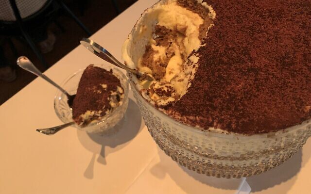The tiramisu is served scooped from a large trifle bowl.