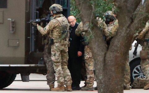 A hostage was escorted out of Congregation Beth Israel on Saturday evening.Credit...Elias Valverde/The Dallas Morning News, via Associated Press