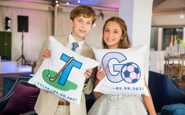 The twins display their golf and soccer-themed pillows.