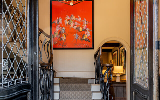 The two entrance doors from the 1800s initially drew Cary to select their home. The background art is from Bali.
