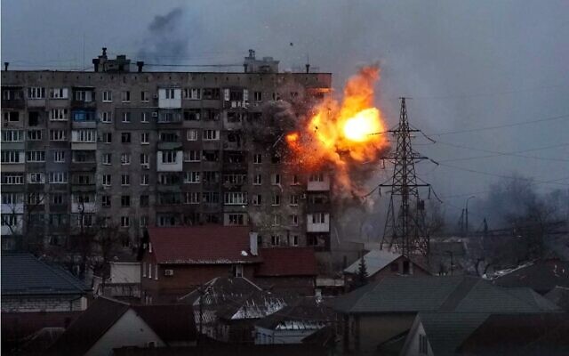 An explosion is seen in an apartment building after a Russian army tank fired in Mariupol, Ukraine, on Friday, Mar. 11
Evgeniy Maloletka/AP