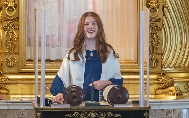Izzy stands at the pulpit, ready to read from the Torah // Dani Weiss Photography.