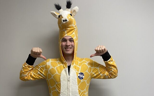 A giraffe costume is worn by Temple Emanu-El’s Rabbi Max Miller during Purim 2020.