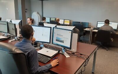 Ventures ATL employees hard at work on data management assignments.