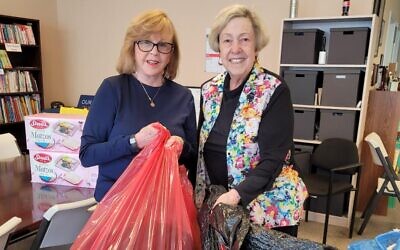 In the NCJW office in Atlanta, Sherry Frank (right) and Linda Davidson helped pile up supplies to be sent to Ukrainian refugees.