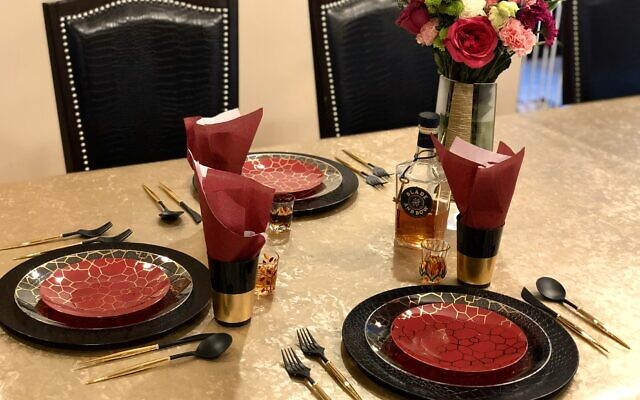 Table set for an intimate family Shabbat meal.