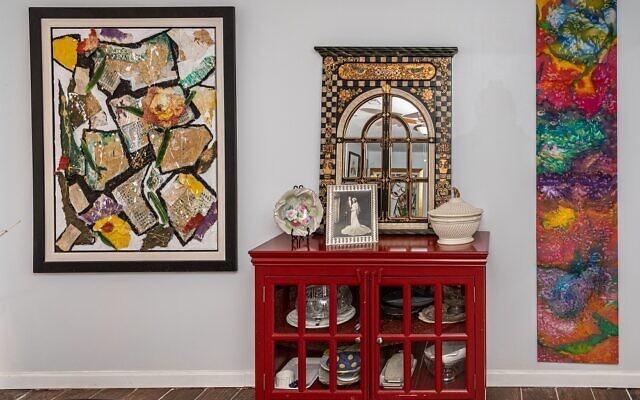Waldman’s foyer features this Cartier soup terrine and gold leaf mirror. Her stretched silk painting is on the right.