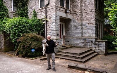 Randy Kessler holds his Shih Tzu-bichon mix, Lily, in front of his Toco Hills home.  //  Photo Credit: Howard Mendel