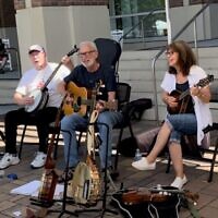 Ross and Teresa Friedman (right) are regular performers at City Springs. Edwin Hall (left) on banjo, Ross on guitar and Teresa on mandolin.
