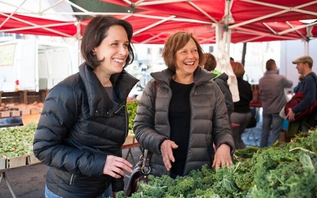 Sara Polon (left) and Meryl Polon (right) search for fresh ingredients at a local farmer’s market.
