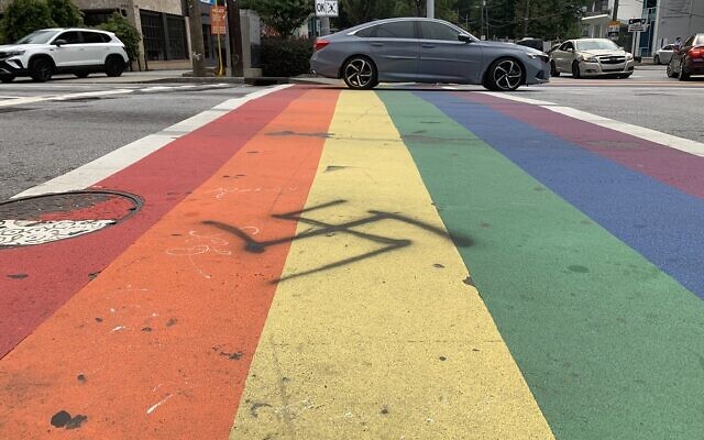 A swastika spray-painted on the “rainbow” crosswalks at the intersection at Piedmont and 10th Street in Atlanta was power-washed away Wednesday night by a city crew within hours of its discovery. // Photo courtesy of Adam Van Wickel