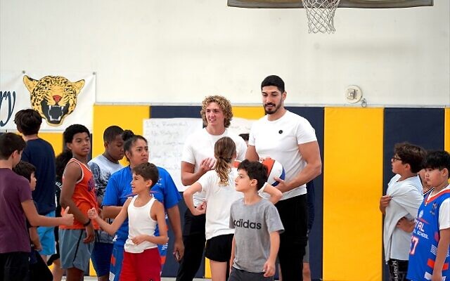 Enes Kanter Freedom and Ryan Turell enjoy a moment with campers during the multifaith hoops clinic held at Sinai Temple in Los Angeles earlier this month. // Photo courtesy of Jennifer Dekel