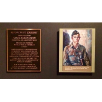 A plaque dedicated to Cohn’s father, Judge Aaron Cohn. The portrait in uniform was painted by a survivor in Ebensee concentration camp in May 1944.