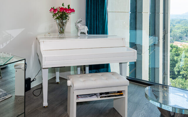 The white piano, always adorned with fresh roses, is one of the few things Truffelman brought from her previous house.