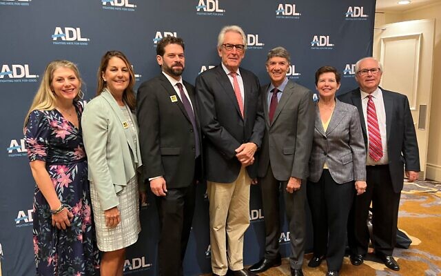 ADL execs posed before the event: Lauren Estrin, Robin Sangston, Eytan Davidson, Walter Jospin, Joel Neuman, Lynne Borsuk, and Bennet Alsher.