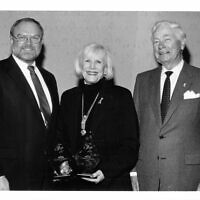 Sandy poses with her broker Rick Brinkman(left) and the late real estate mogul Harry Norman(right).