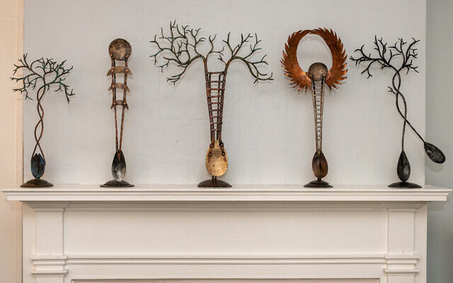 Below: Sephora by her home fireplace mantel with five small metal sculptures from the “Avirons” series. These magical oars are inspired by paddle boards and ancient scepters, in bronze, copper and stainless steel. “Avirons,” meaning “oars” in French, are a mythical tool for transcendence. // Photo Credit by Howard Mendel.