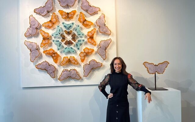 Marlene Rose poses in front of her “Butterfly Mandala” offered at $99,000.