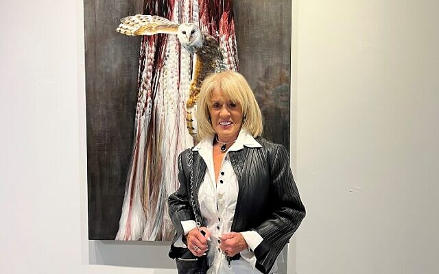 Joanne Truffelman had just returned from a New York art jaunt. Here she poses in front of an Amy Rader painting, centered about a bird of prey.