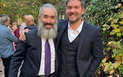 Rabbi Eliyahu Schusterman (left) expressed appreciation for Andy Bibliowicz, who won one of the Young Professionals Awards.