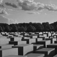 The Holocaust Memorial in Berlin contains 2,711 grey concrete boxes in rows that invite the visitor to walk among them.  //  Credit Jason Langer