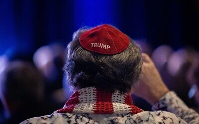 A man wearing a Trump yarmulke listens as former President Donald J. Trump speaks to the Republican Jewish Coalition annual meeting.