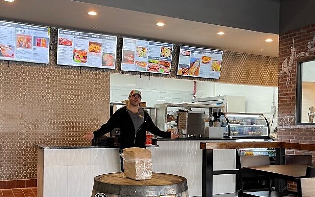 Robert Miller inspects and enjoys his brand-new Dunwoody space for 101 Bagel Café.
